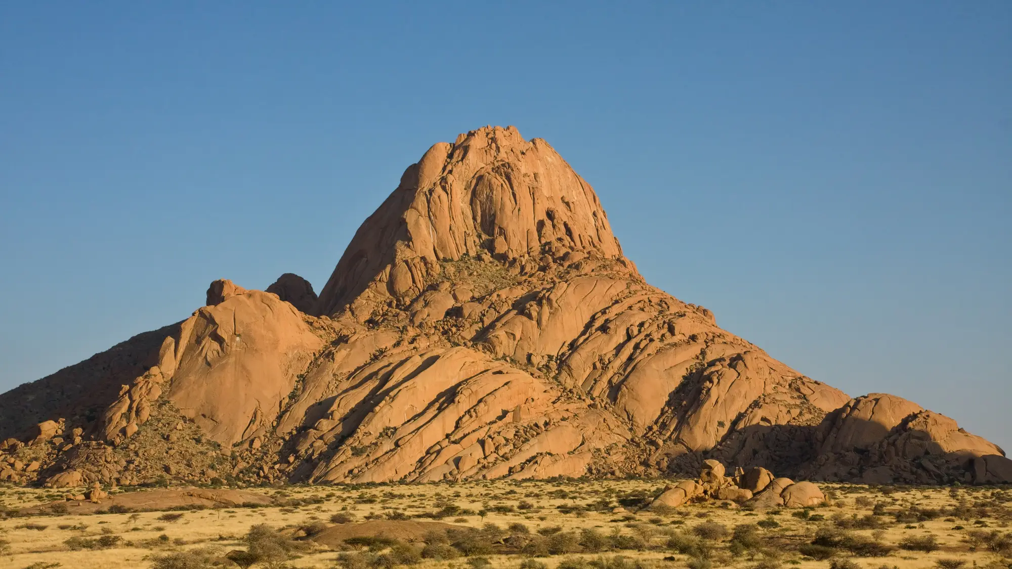 Spitzkoppe glowing at first light above the Namibian plains